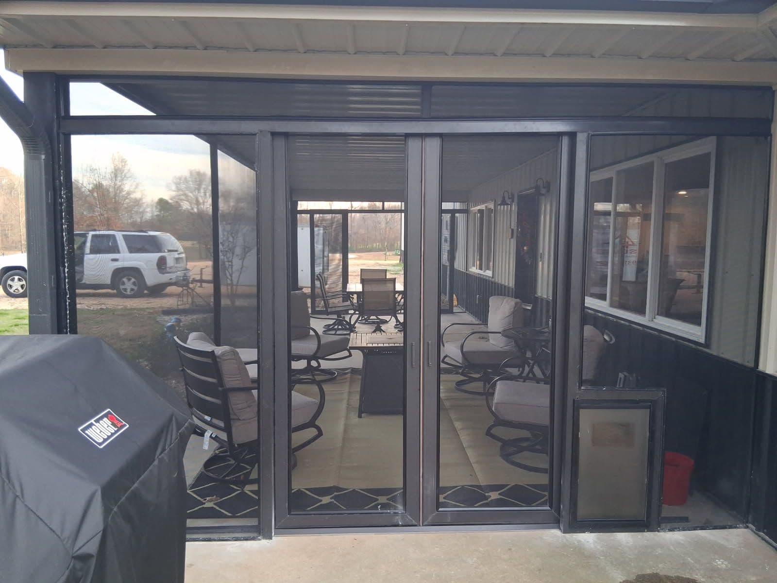Enhance Outdoor Living with a Screened-In Porch and Sliding French Doors image